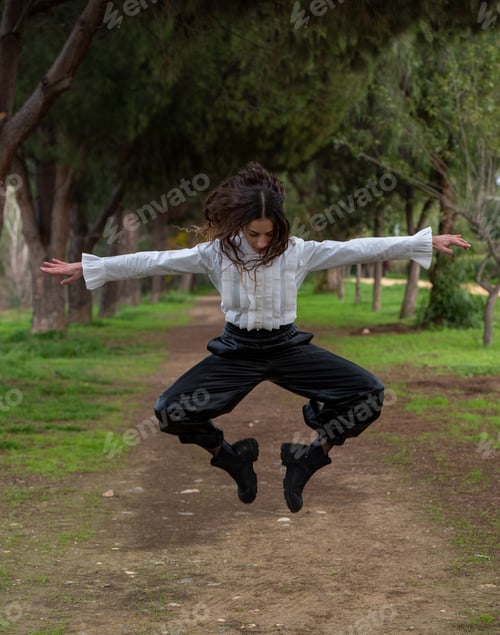 Preview: Young woman dancing outdoors. Dance performance in the street