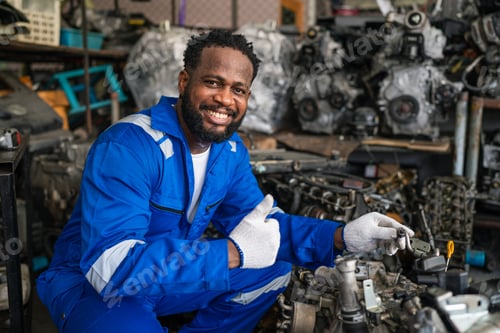 Preview: Portrait of man auto mechanic working at car repair shop with looking.