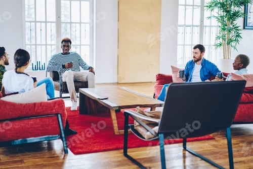 Preview: Young trendy people communicating in loft hostel apartment