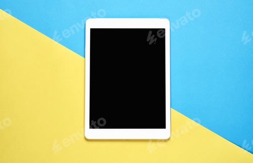 Preview: Top view, Modern workplace with tablet placed on a pastel yellow background