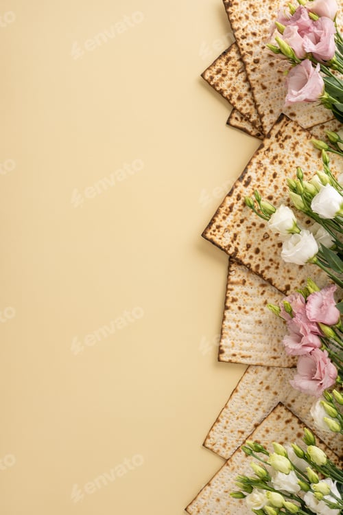 Preview: Matzah vertical pieces arranged with pink and white flowers on a beige background