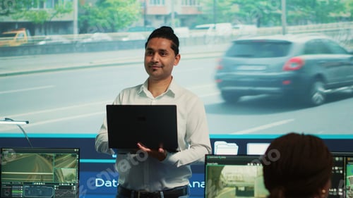 Preview: Indian man team leader coordinating staff to observe urban surveillance footage