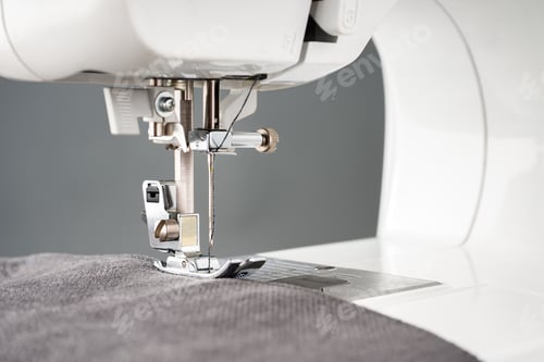 Preview: Modern sewing machine with gray fabric