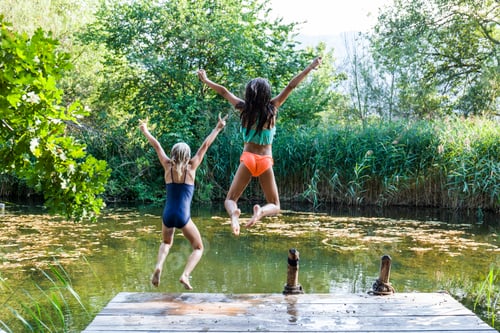 Preview: Two carefree girls jumping into pond