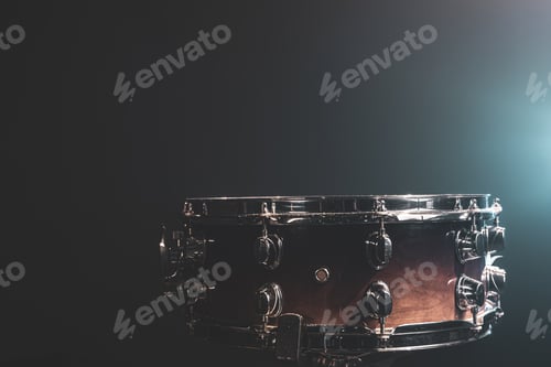 Preview: Close-up of a snare drum on a dark background with stage lights.