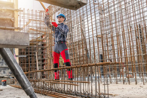 Preview: Construction Worker Managing Rebar Framework at a Building Site