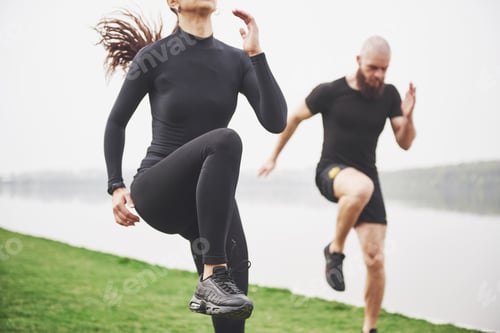 Preview: A young couple enjoys playing sports in the morning in the open air. Warm up before exercise