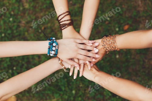 Preview: United hands of girlfriends closeup, young girls in boho bracelets