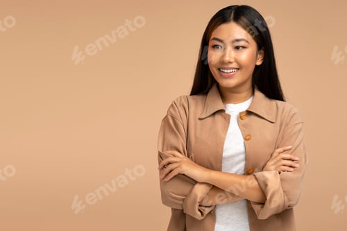 Preview: Happy woman looking away, posing arms crossed, expressing positive