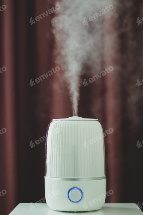 Preview: White ultrasonic humidifier on a dark background. Water vapor.