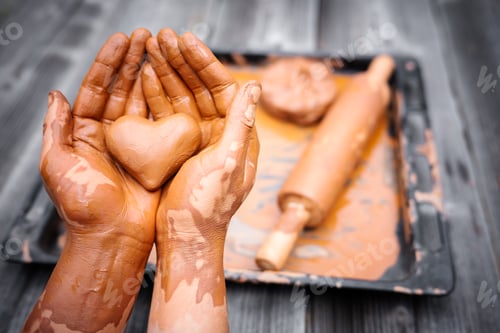 Preview: Heart made of potter's clay in the hands of a master potter