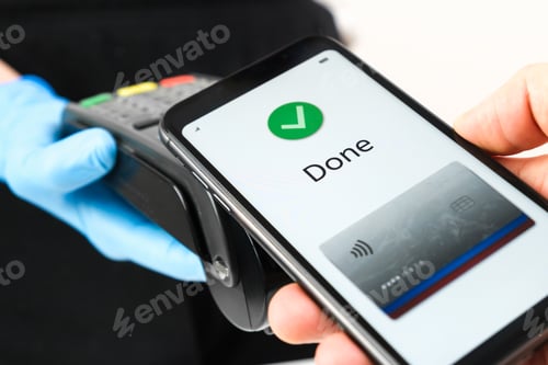 Preview: Close up of woman hand in rubber gloves holding a pos terminal or swiping machine and man hand
