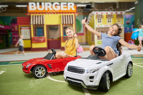 Preview: Little girls having fun in leisure center for kids.