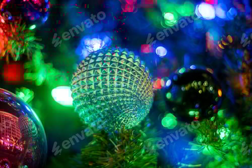 Preview: Closeup shot of bulbs and lights on a Chrstimas tree, concept of holidays