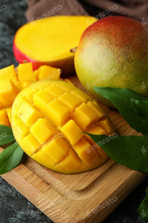 Preview: Tasty ripe mango fruit on black smokey table