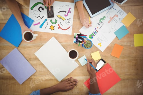 Preview: Overhead View Of Cropped Hands Working At Desk In Creative Office