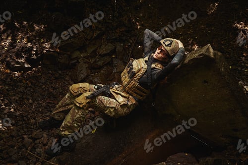 Preview: Woman in military uniform relaxing on groud