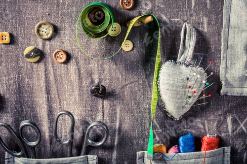Preview: Background made of buttons, needles and threads in sewing workshop