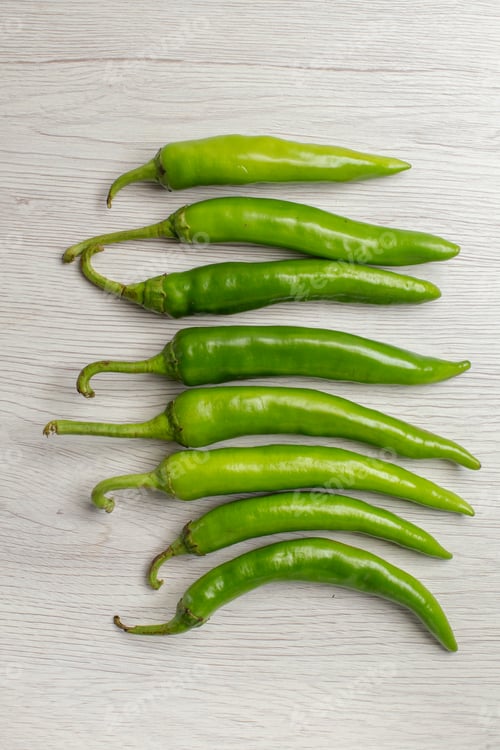 Preview: top view green spicy peppers on a white background hot edgy vegetable ripe salad color photo