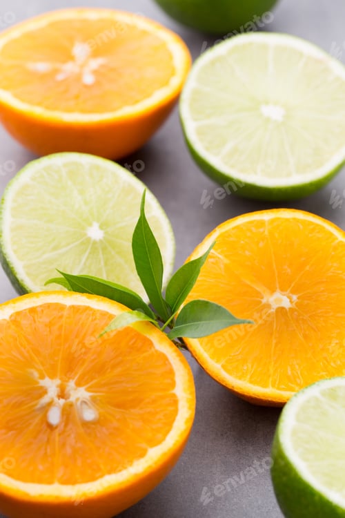 Preview: Mixed citrus fruit lemons, orange, kiwi, limes on a gray background.