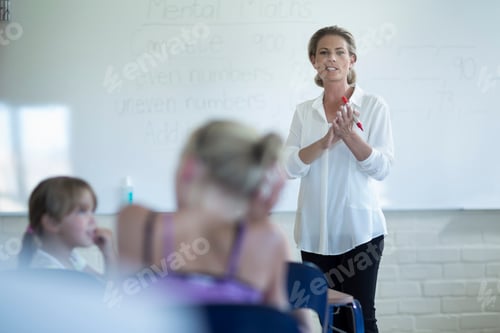Preview: Teacher in classroom talking at whiteboard