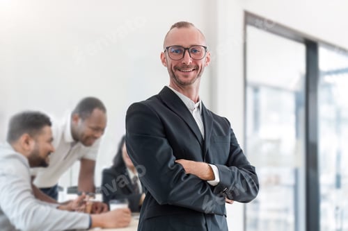 Preview: Portrait of an attractive young businessman A successful business executive stands with his arms