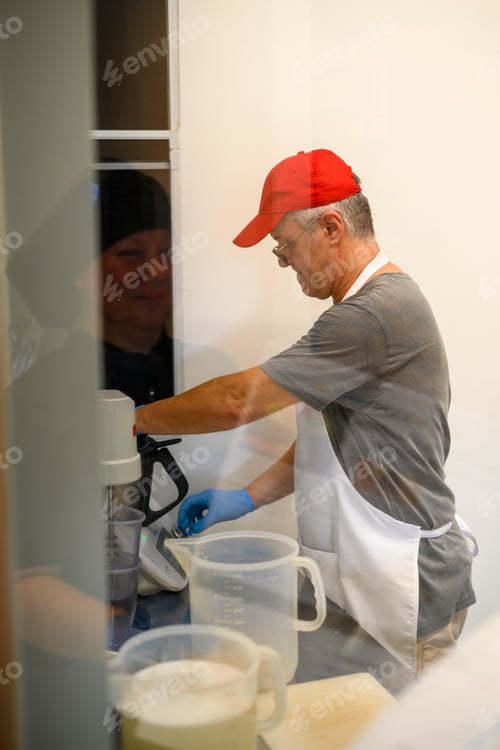 Preview: Man Mixing Ingredients in a Kitchen