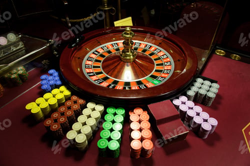 Preview: close-up chips and roulette at the casino on the red table