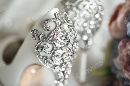 Preview: Brides wedding shoes with a bouquet with roses