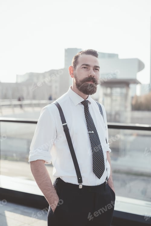 Preview: Portrait of stylish businessman with hands in pockets in city