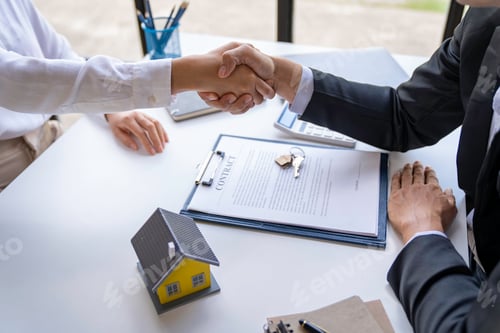 Preview: The estate agent and client are shaking hands after a good deal home loan after discussing and signi