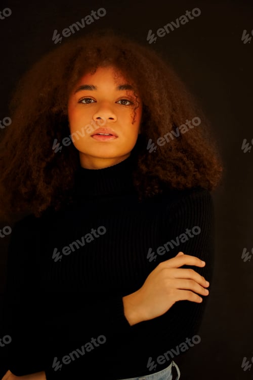 Preview: African beauty. Smiling young african-american woman in black clothes isolated on dark background