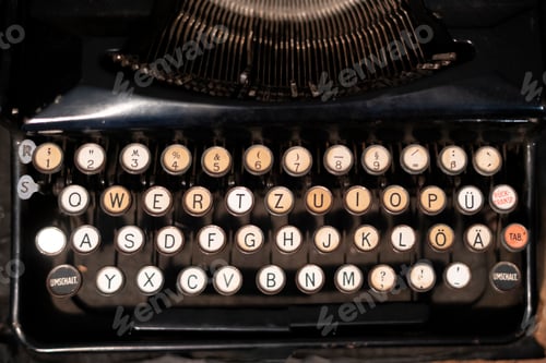 Preview: an old vintage black typewriter machine on the table