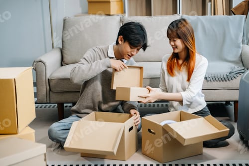Preview: Young couple with big boxes moving into a new house, new apartment for couple, young asian man