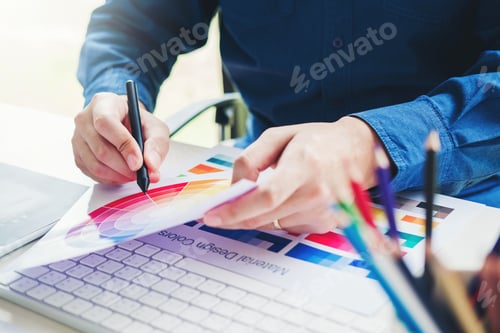 Preview: Graphic designer drawing on graphics tablet at workplace