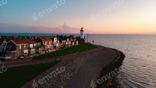 Preview: Urk Flevoland Netherlands sunset at the lighthouse and harbor of Urk Holland. Fishing village Urk