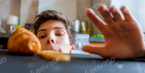 Preview: young man peeking from the table and stealing food