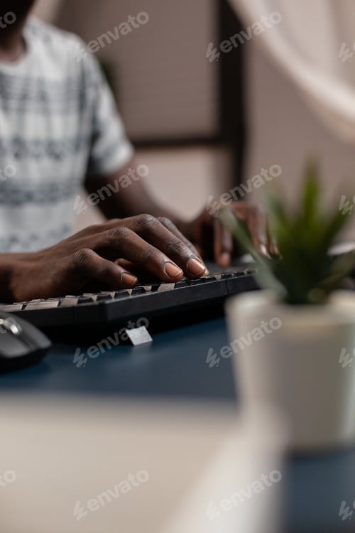 Preview: Closeup of african american young businessman hand typing communication project