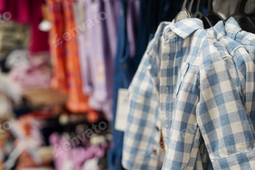 Preview: Children clothes hanging on hangers in the shop