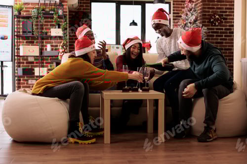 Visualização: Pessoas alegres servindo vinho em copos na festa de Natal