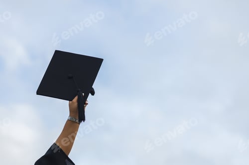 Preview: graduate showing mortarboard by hand