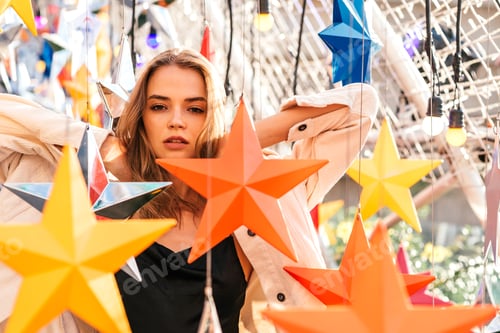 Woman Posing with Colorful Star Decorations