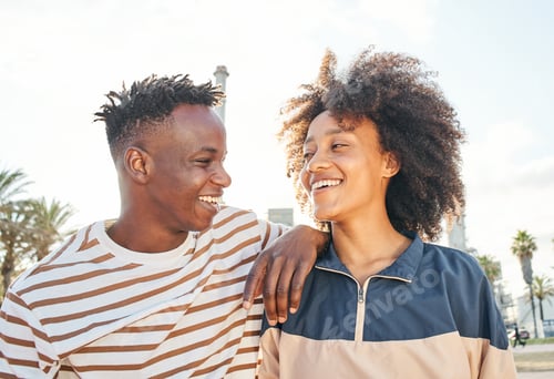 Preview: Portrait medium shot of a young black couple looking at each other smiling