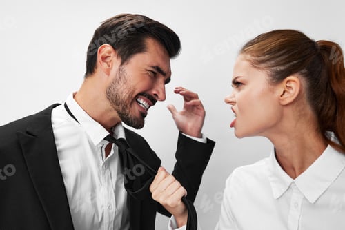 Preview: Man and woman pulling on tie anger business looking at each other screaming with hands up in white
