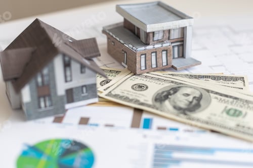 Preview: paper house model on background of US dollars banknotes. Housing market, purchase or rental of real