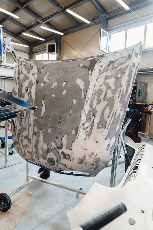 Preview: Painting and drying of car body parts after applying putty and paint on hood in the body repair shop