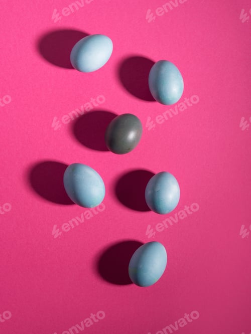 Preview: Blue easter hen eggs on dark pattern on bold pink background with shadows