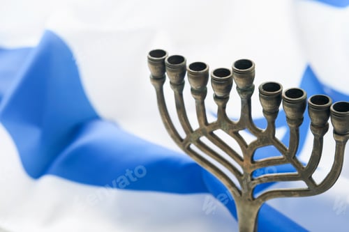 Preview: Happy Hanukkah. Hanukkah old Menorah against background of the Israeli flag with sunlight or bokeh o