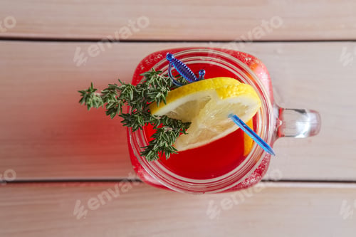 Preview: Cup of cranberry juice with citrus and rosemary
