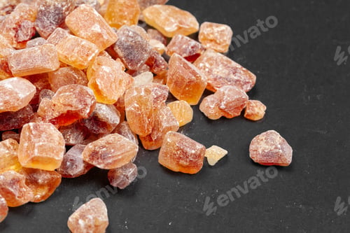 Preview: brown sugar rock organic crystalline close up on dark background